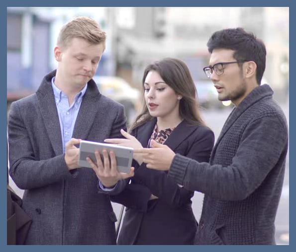 Young street evangelists spreading the Social Kingship of Christ using an iPad